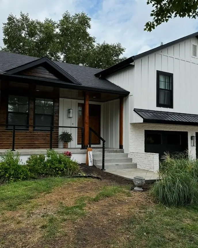 The same home with new white board-and-batten siding