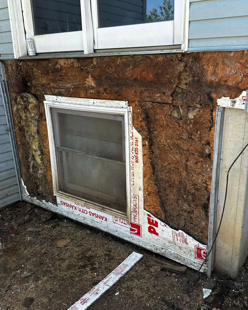 Rotted wall sheathing behind old siding